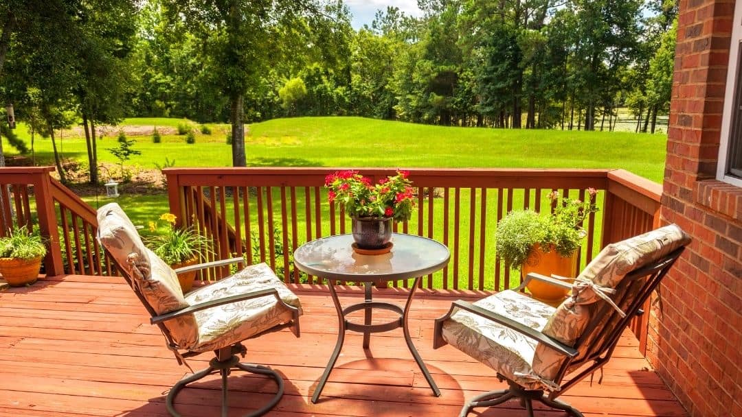 A nice deck with a view of backyard.